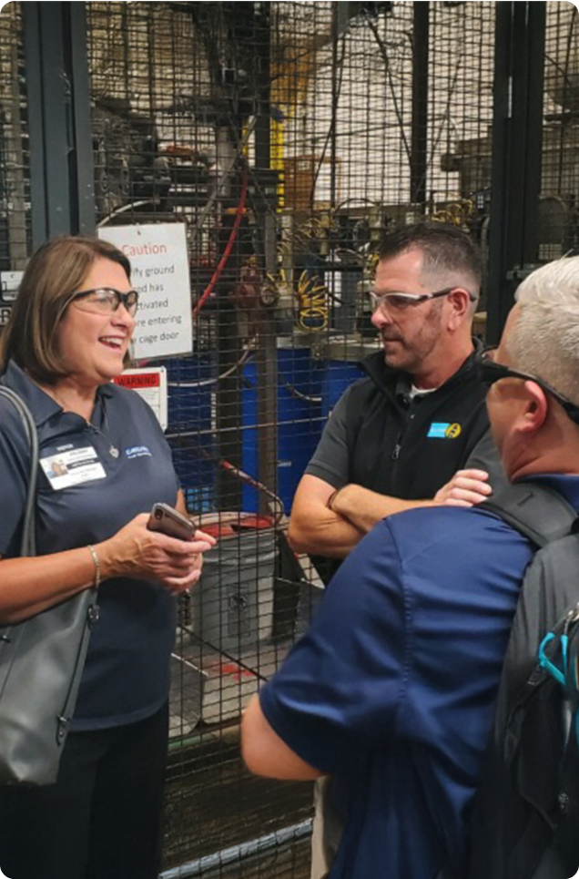 Factory team discussing paint line system upgrades.